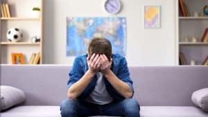 Image of a man sitting on a couch with head in hands. There are stress management techniques you can use at home. An anxiety therapist in North Carolina can help whether you are in Raleigh, Asheville or anywhere else in North Carolina. Reach out to learn about anxiety treatment in Asheville, North Carolina.